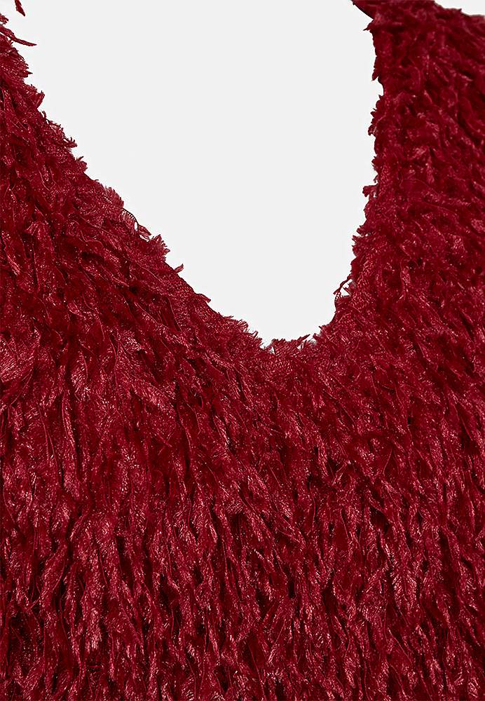 Festtopp med fjærlignende materiale